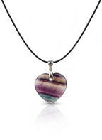 Treasured Energies heart-shaped purple and green fluorite crystal pendant on a black cord necklace.