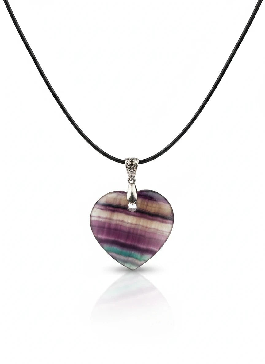 Treasured Energies heart-shaped purple and green fluorite crystal pendant on a black cord necklace.
