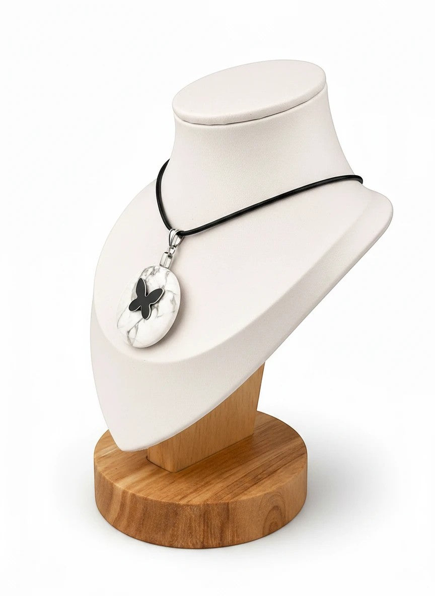 Treasured Energies howlite donut ring necklace with a black butterfly pendant on a black cord displayed on a bust