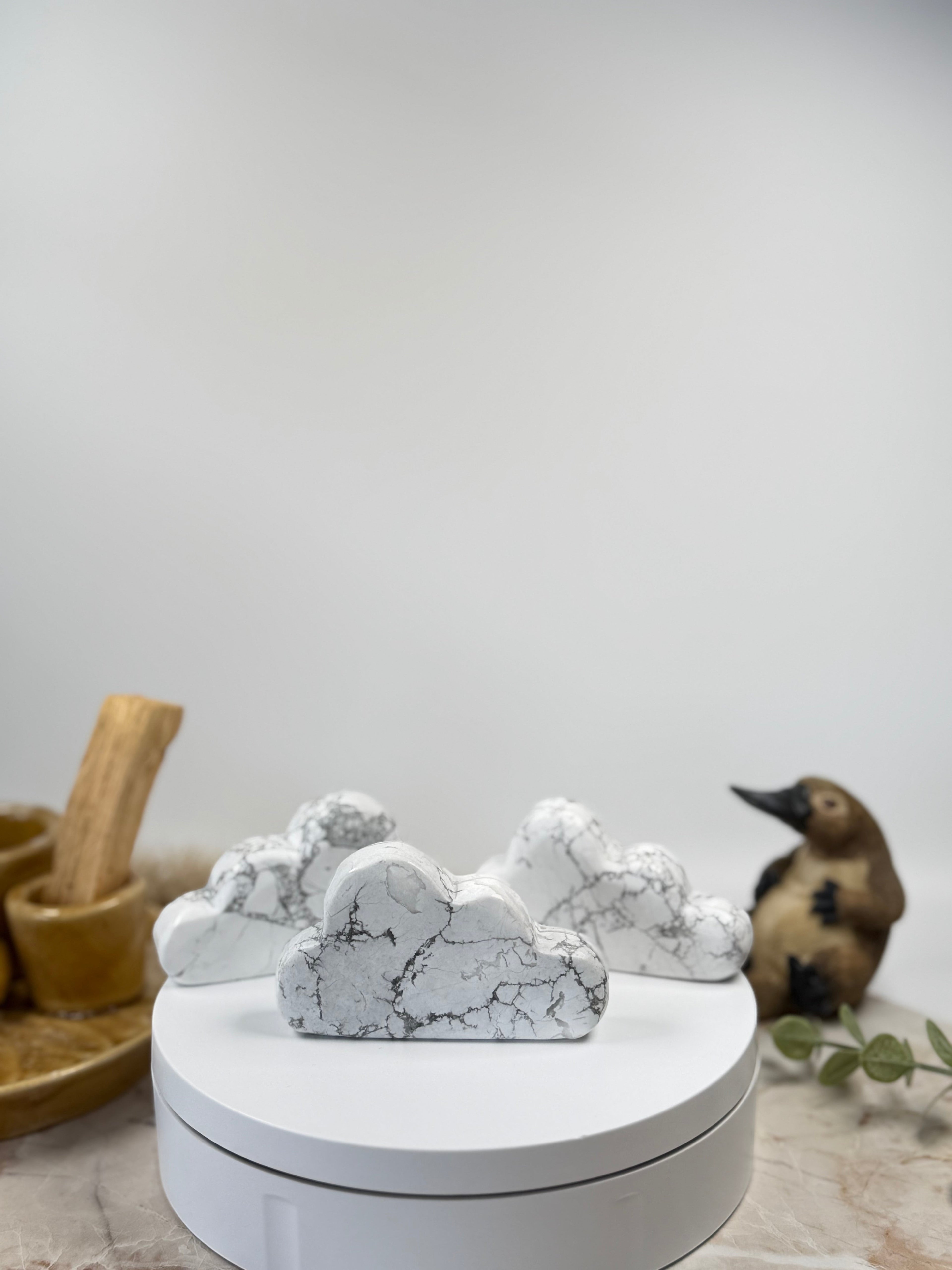 Treasured Energies hand carved white howlite crystal cloud with grey veining on a white display stand