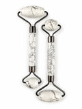 Treasured Energies dual-ended facial massage rollers in white Howlite stone with black veining and dark metal hardware.