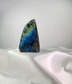 Treasured Energies large labradorite freeform crystal with vibrant blue and gold labradorescence on white silk