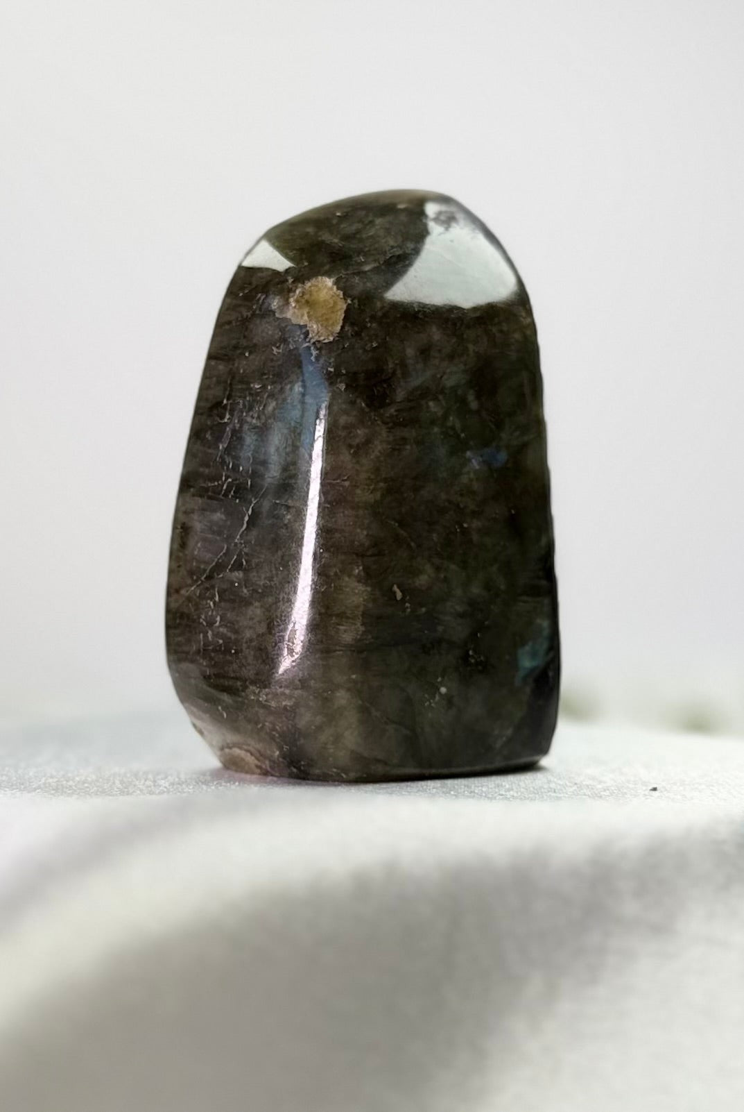 Treasured Energies polished labradorite crystal freeform with dark grey tones and subtle labradorescence