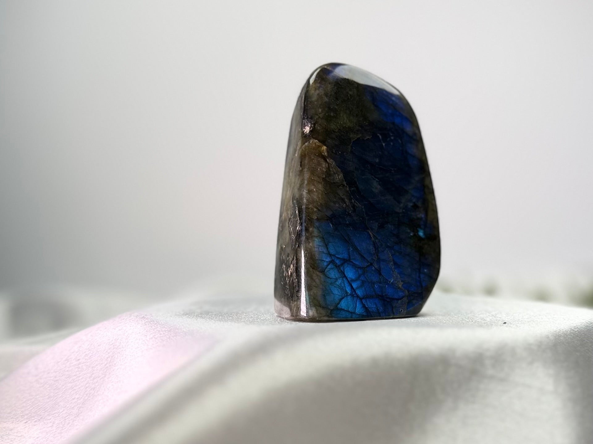 Treasured Energies polished labradorite freeform crystal with vibrant blue labradorescence and organic stone texture.