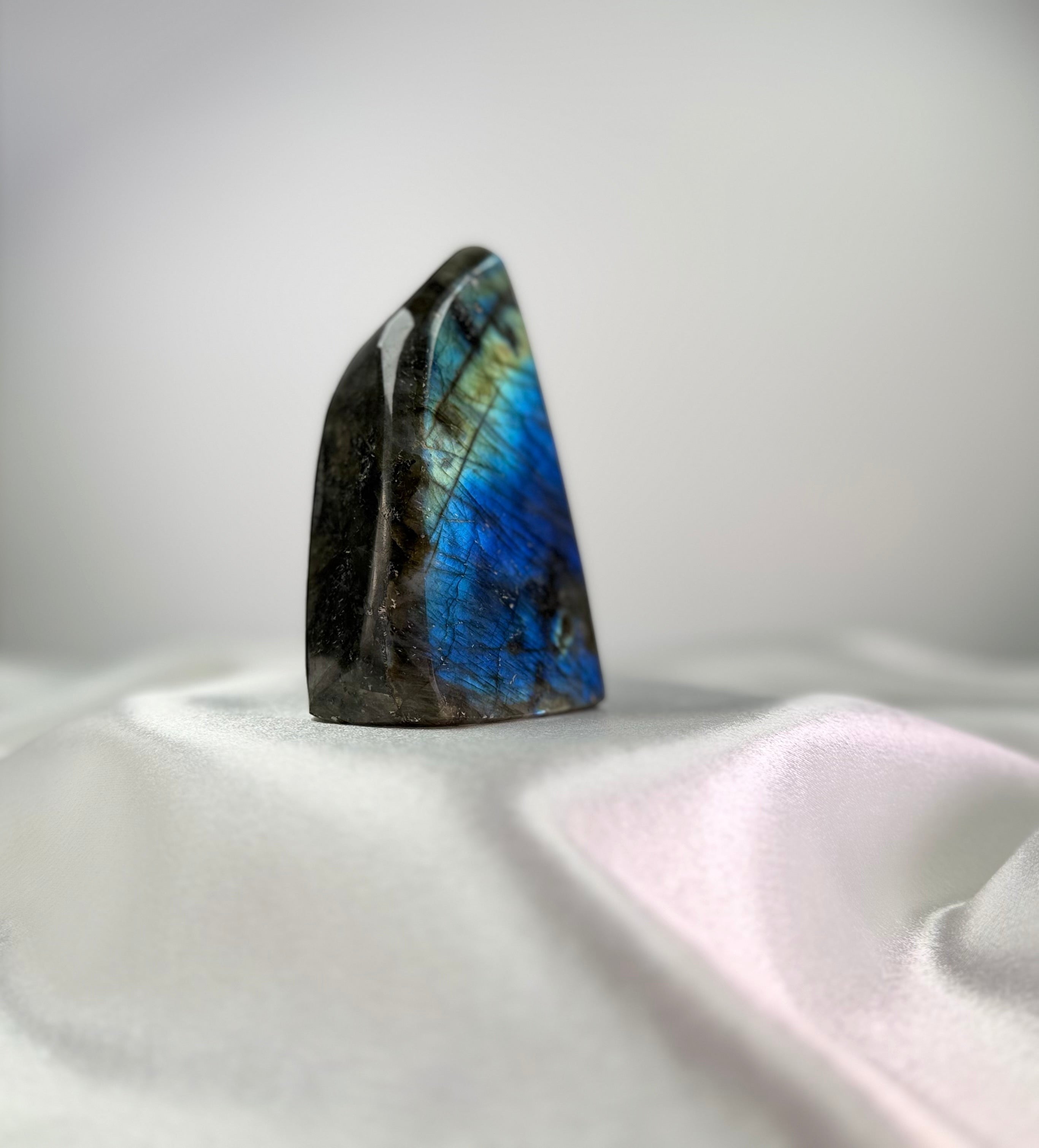 Treasured Energies large polished Labradorite freeform crystal displaying vibrant blue and gold labradorescence.