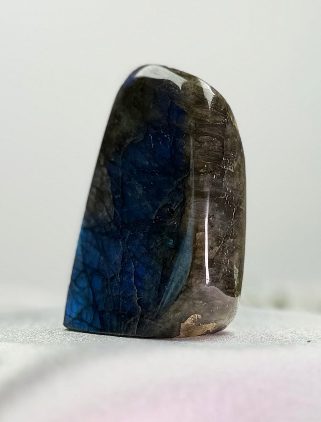 Treasured Energies polished labradorite freeform crystal with vibrant blue labradorescence and organic shape.