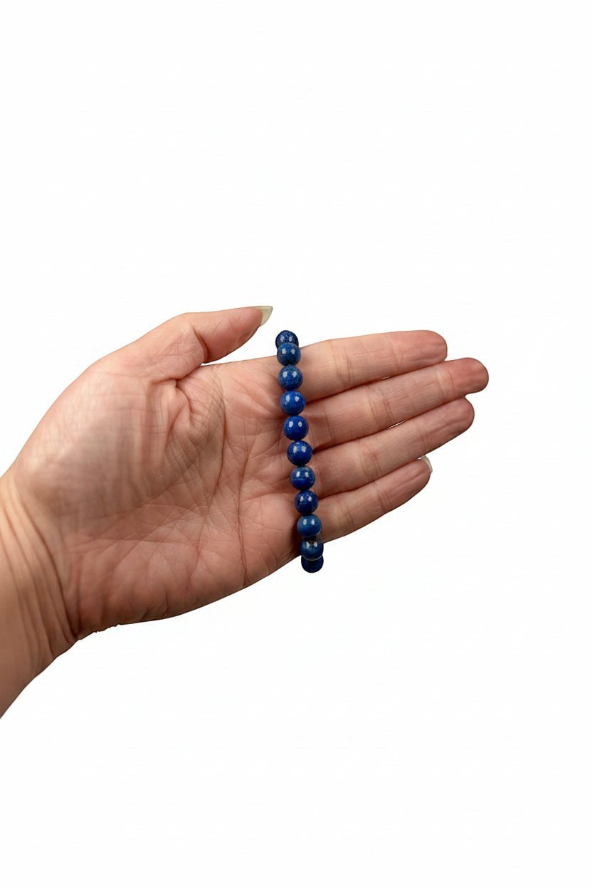 Treasured Energies natural lapis lazuli beaded elastic bracelet held in a palm