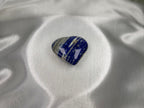 Treasured Energies polished Lapis Lazuli heart crystal with deep blue, white, and gold pyrite inclusions on silk.