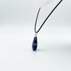 Treasured Energies Lapis Lazuli teardrop pendant necklace on a black cord against a clean white background.