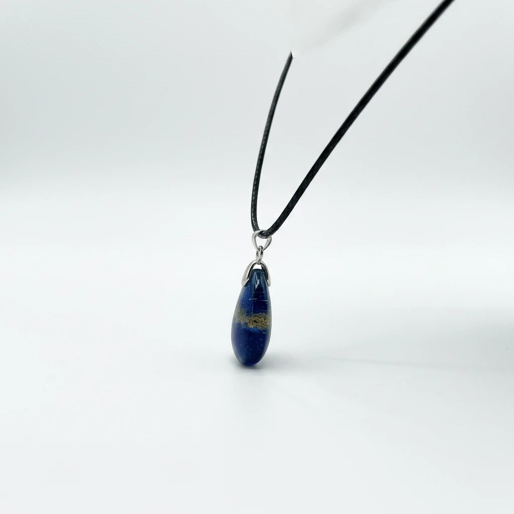 Treasured Energies Lapis Lazuli teardrop pendant necklace on a black cord against a clean white background.