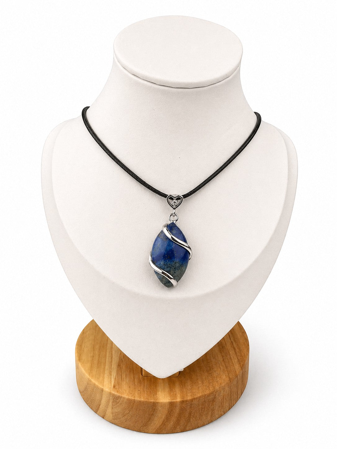 Treasured Energies Lapis Lazuli crystal pendant necklace on a black cord with silver wire wrapping on a display bust
