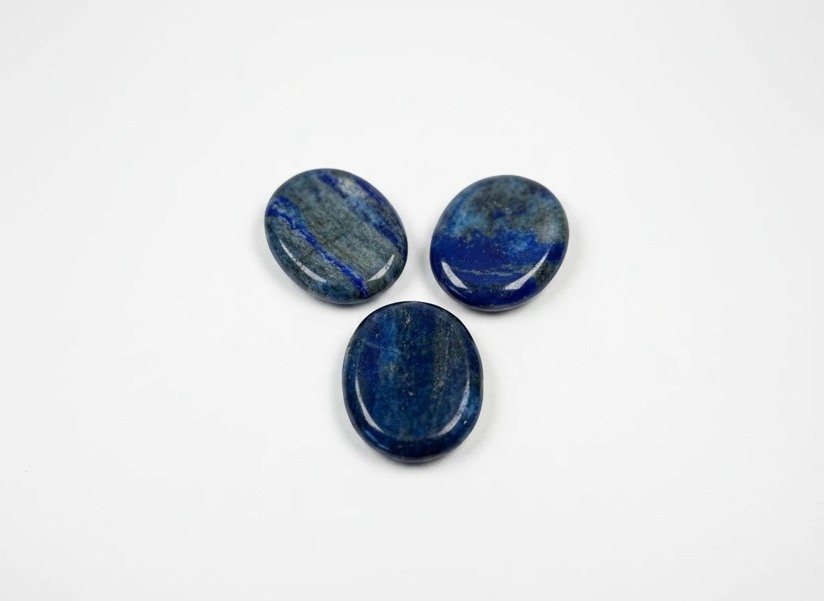 Three smooth, polished Lapis Lazuli worry stones with deep blue colour and golden pyrite flecks from Treasured Energies