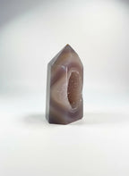 Treasured Energies polished lilac and grey agate crystal tower point featuring a sparkling druzy geode center.