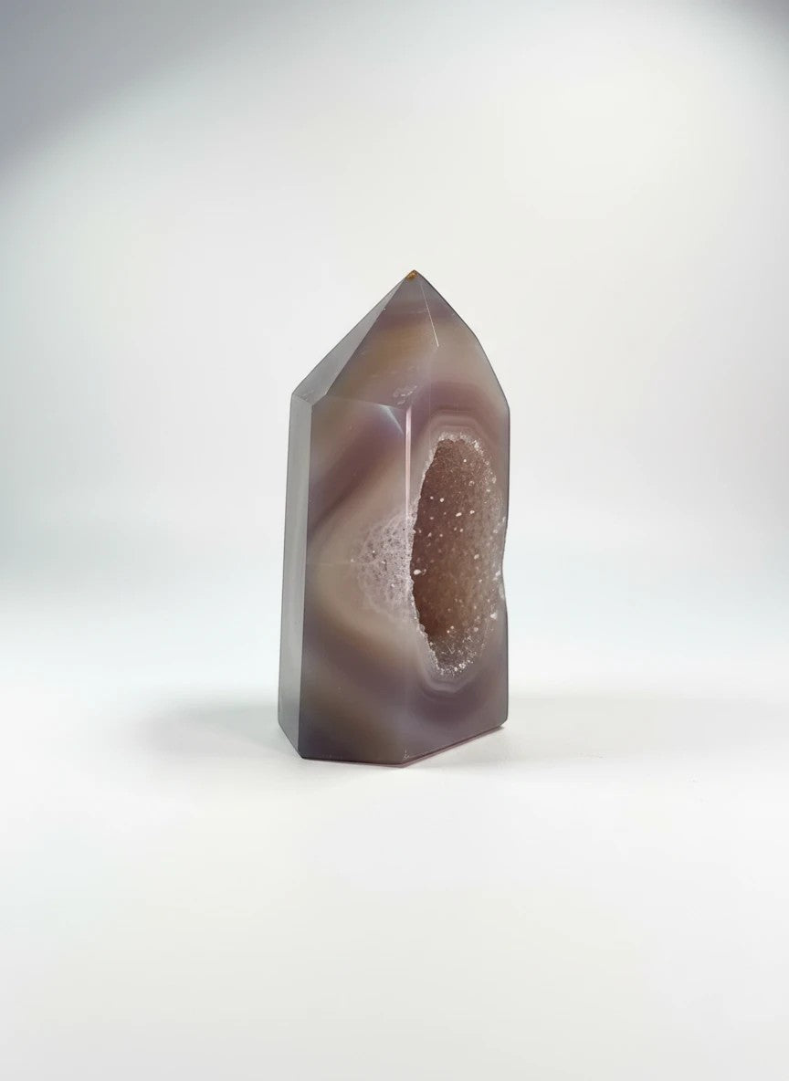Treasured Energies polished lilac and grey agate crystal tower point featuring a sparkling druzy geode center.