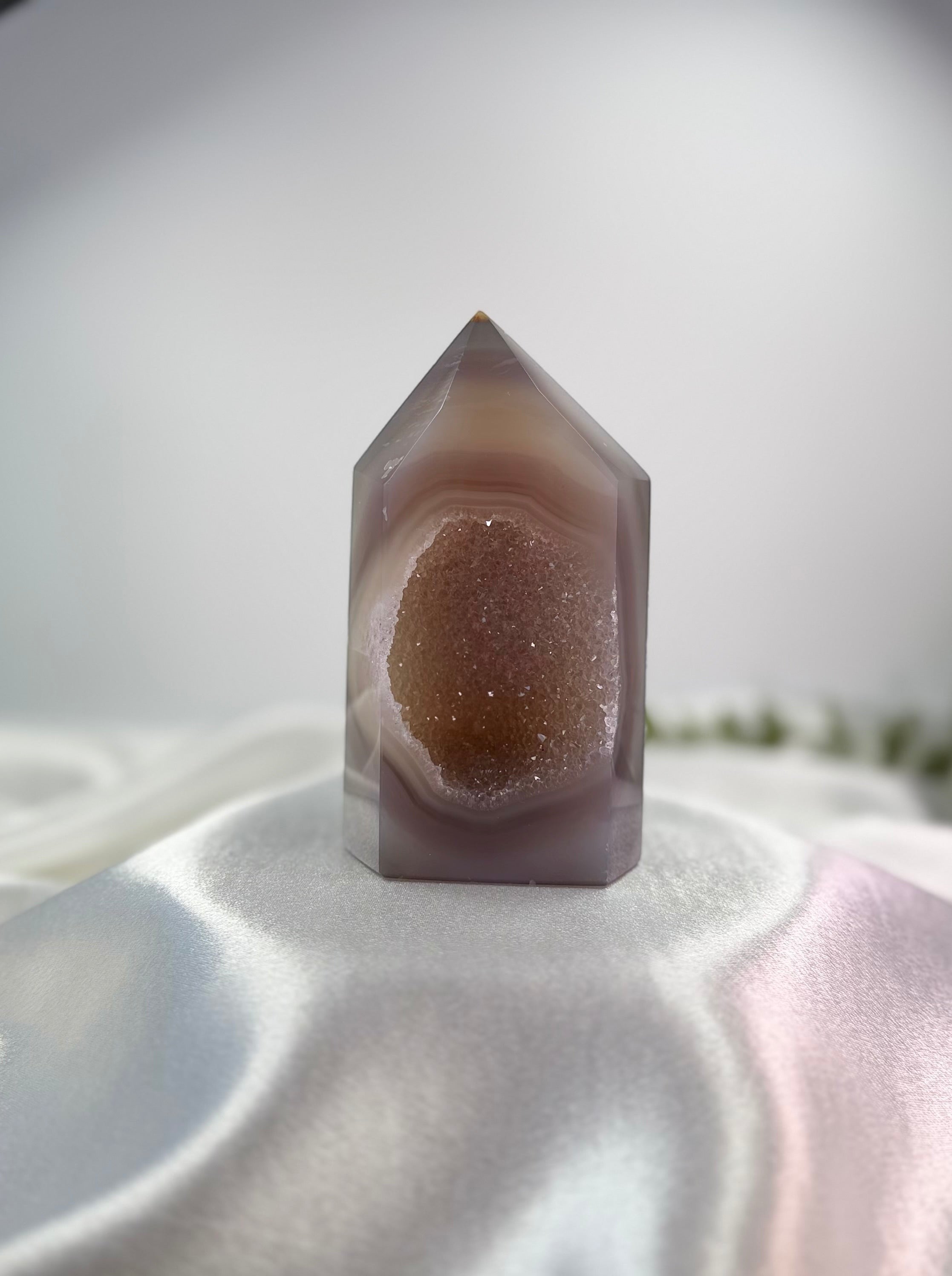 Treasured Energies polished lilac and grey agate crystal tower point featuring a sparkling druzy geode center.