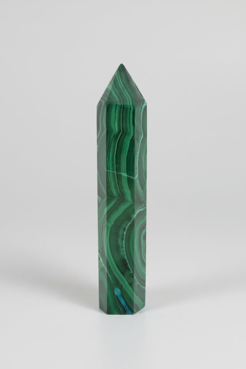 Treasured Energies polished malachite crystal tower featuring vibrant green banding and a pointed top for energy focus.
