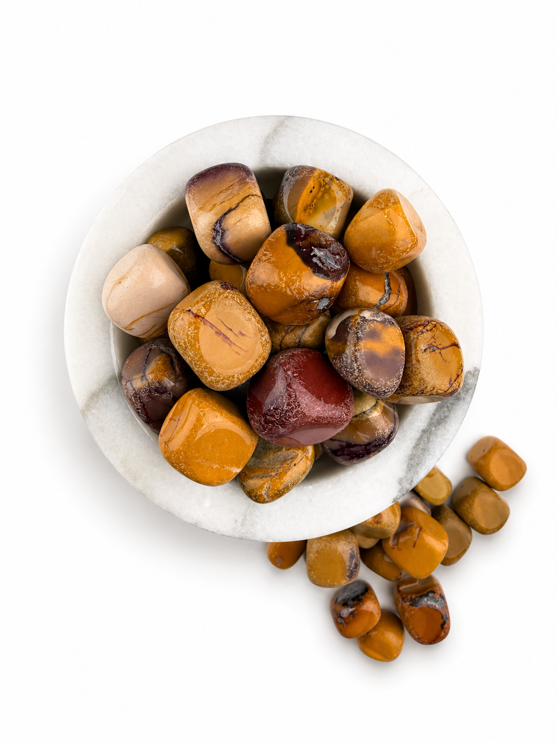 Treasured Energies Mookaite Jasper tumbled stones in a white marble bowl with earthy red, burgundy, and yellow tones.