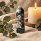 Treasured Energies polished Moss Agate crystal tower with green and white moss-like inclusions on a textured fabric