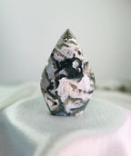 Treasured Energies polished moss agate flame crystal sculpture with green and white mineral inclusions and druzy pockets.
