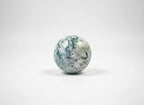 Treasured Energies polished moss agate crystal sphere with green moss-like inclusions on a white background