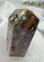 Treasured Energies polished Ocean Jasper crystal tower with orbicular patterns in grey, green, and brown tones.