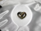 Treasured Energies large heart-shaped Ocean Jasper crystal with rhythmic green, brown, and black patterns on silk.