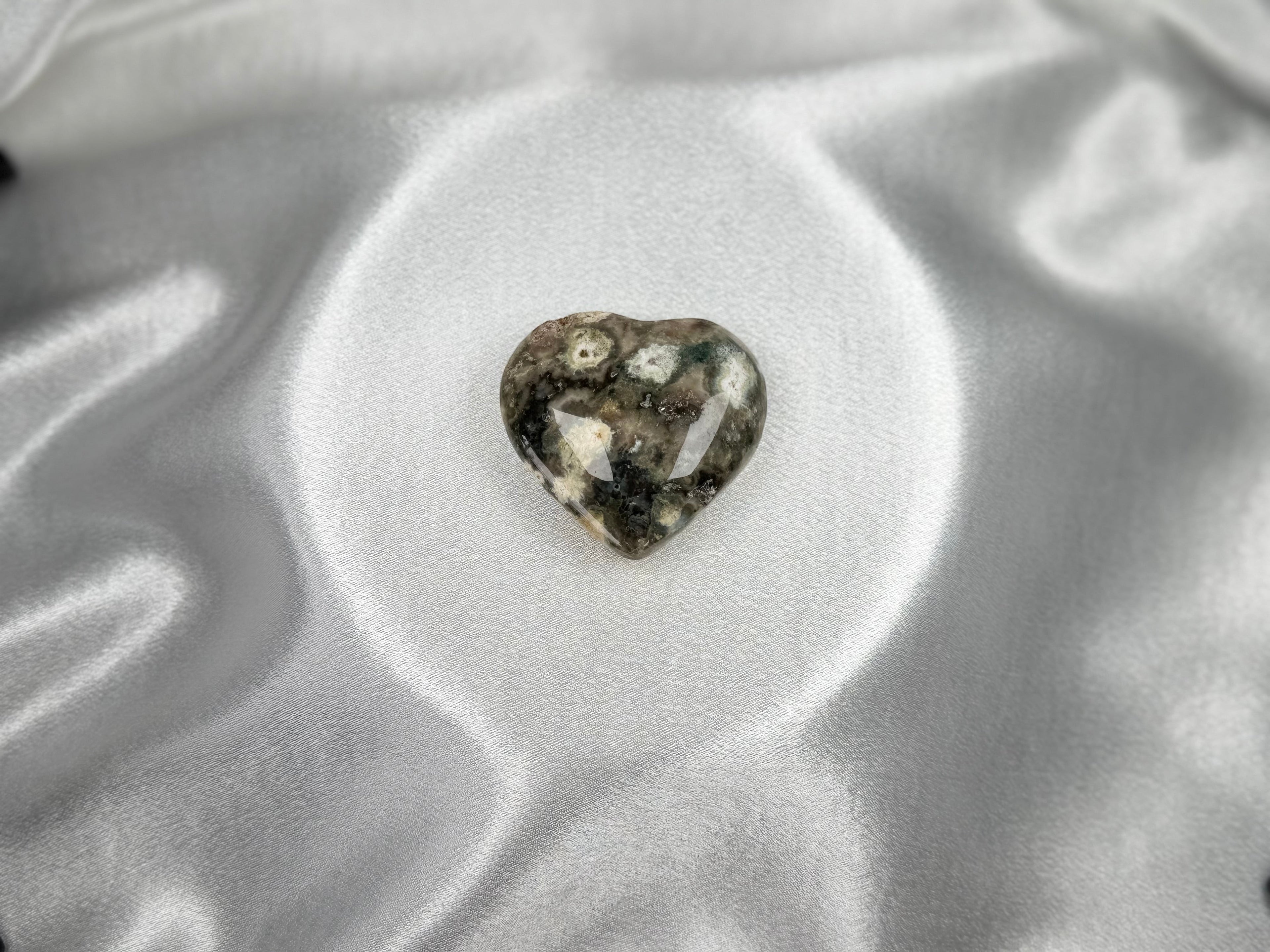 Treasured Energies large heart-shaped Ocean Jasper crystal with polished grey, green, and white orbicular patterns.