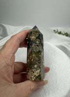 Treasured Energies Ocean Jasper crystal tower held in hand, featuring dark green, brown, and cream orbicular patterns.