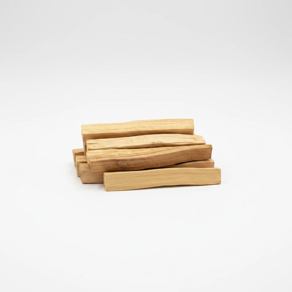 Treasured Energies natural palo santo wood sticks for smudging and aromatherapy stacked on a white background