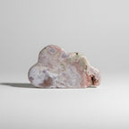 Treasured Energies pink amethyst crystal specimen carved into a soft cloud shape with natural mineral textures.