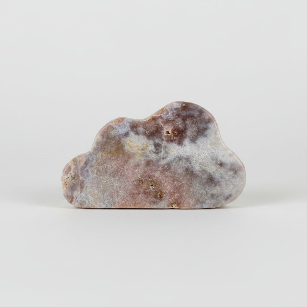 Treasured Energies pink amethyst crystal carved into a smooth cloud shape with natural mineral patterns.