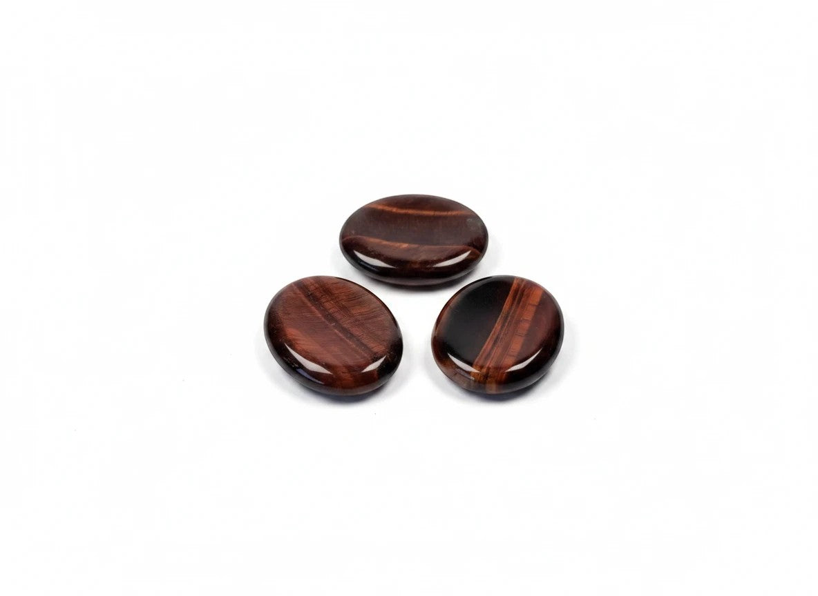 Treasured Energies red tiger's eye worry stones with smooth, polished surfaces and deep reddish-brown banded patterns.