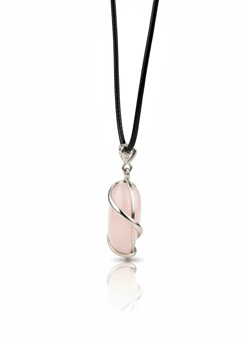 Treasured Energies rose quartz crystal pendant wrapped in silver wire on a black cord necklace against a white background.