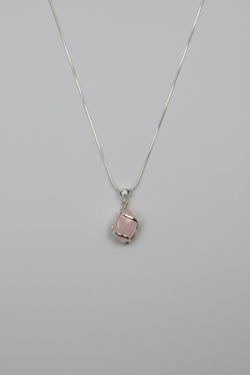 Treasured Energies rose quartz crystal pendant necklace with silver wire wrapping on a delicate silver chain