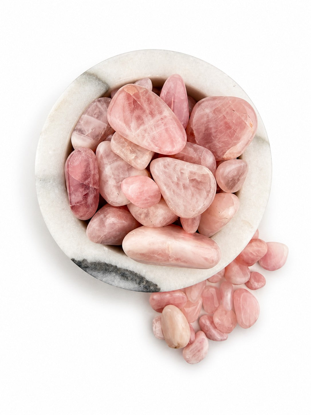 Treasured Energies tumbled rose quartz crystals in a white marble bowl for healing and meditation