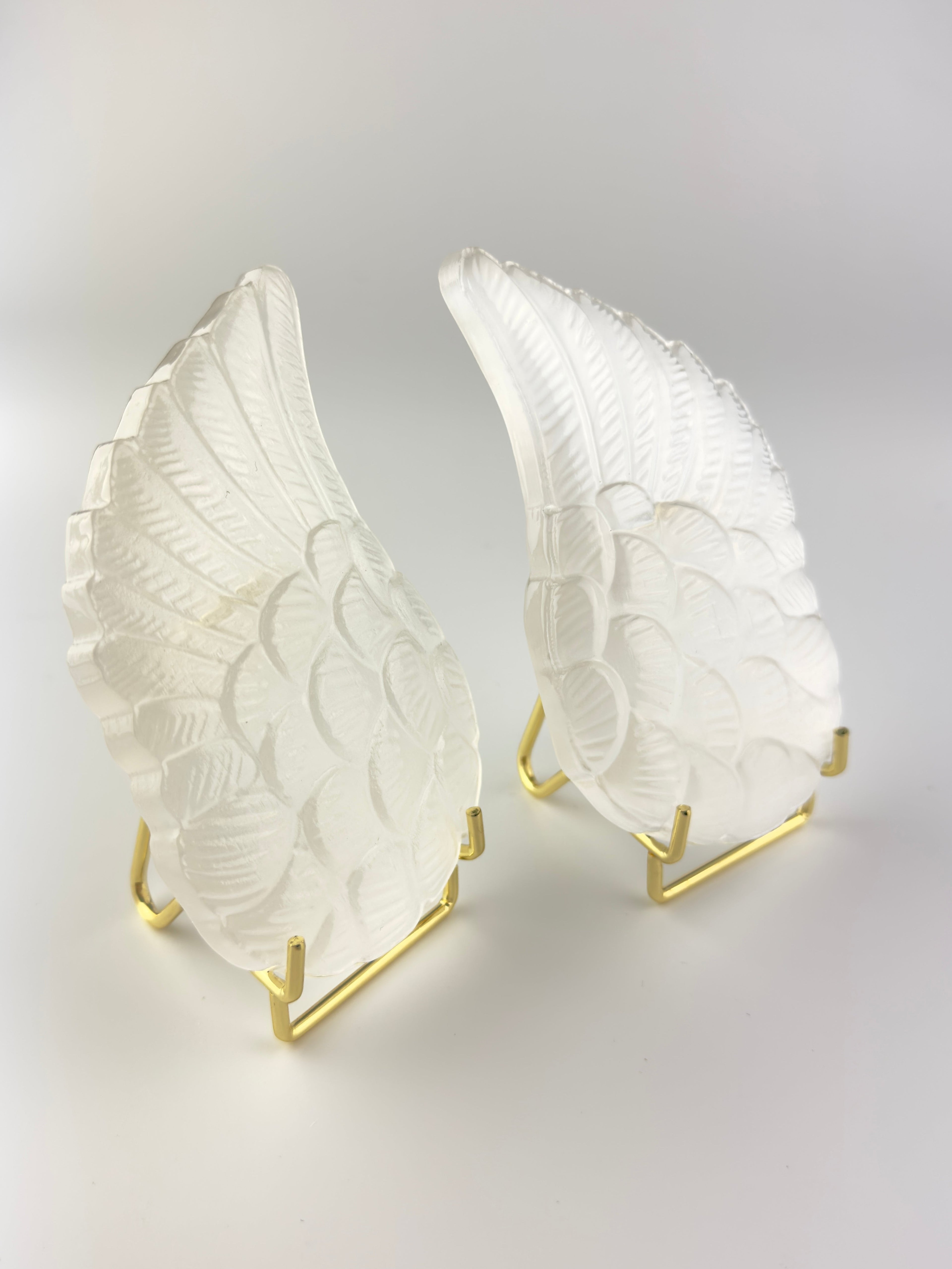 Treasured Energies pair of carved white selenite angel wings displayed on gold metal stands against a white background.