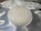 Treasured Energies 14cm round white selenite charging plate with a delicate engraved flower of life pattern