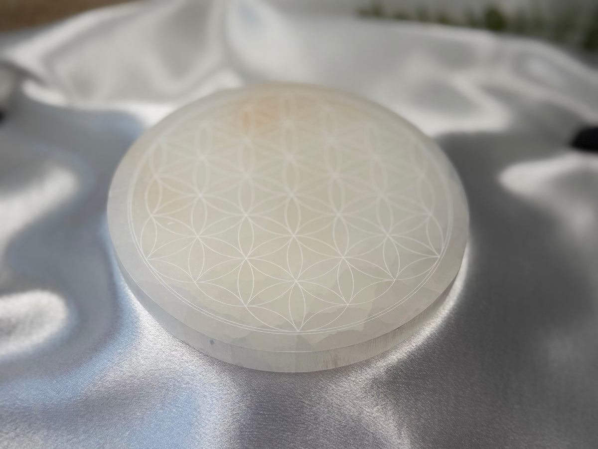 Treasured Energies 14cm round white selenite charging plate with a delicate engraved flower of life pattern