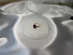 Treasured Energies 8cm round white selenite charging plate with sacred geometry engraving holding a gold ring