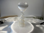 Treasured Energies translucent white selenite crystal heart sculpture with a decorative spiral pedestal base