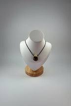 Treasured Energies Septarian crystal pendant necklace on a black cord displayed on a white mannequin bust