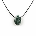 Treasured Energies seraphinite crystal pendant on a black cord necklace featuring deep green and white feathered patterns