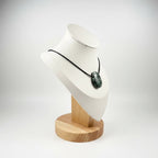 Treasured Energies seraphinite crystal pendant necklace on a black cord displayed on a white mannequin bust