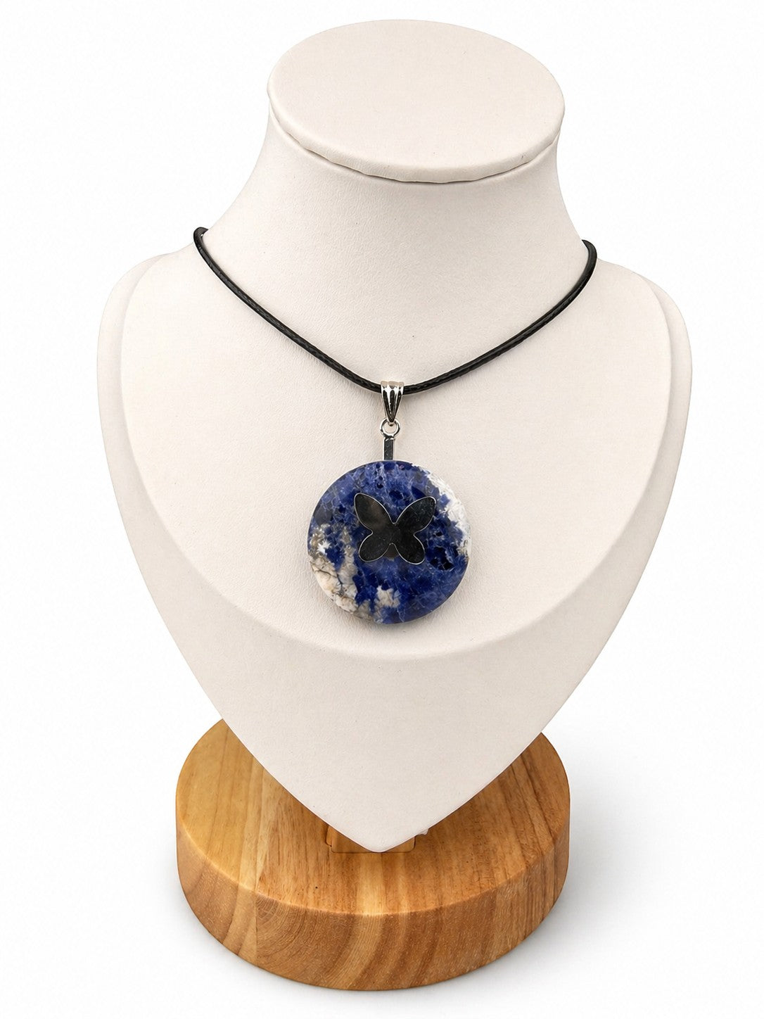 Treasured Energies sodalite donut ring necklace with a black butterfly pendant on a black cord, displayed on a bust.