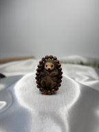 Treasured Energies gold tiger eye crystal beaded bracelet featuring a cute carved hedgehog figurine on white silk