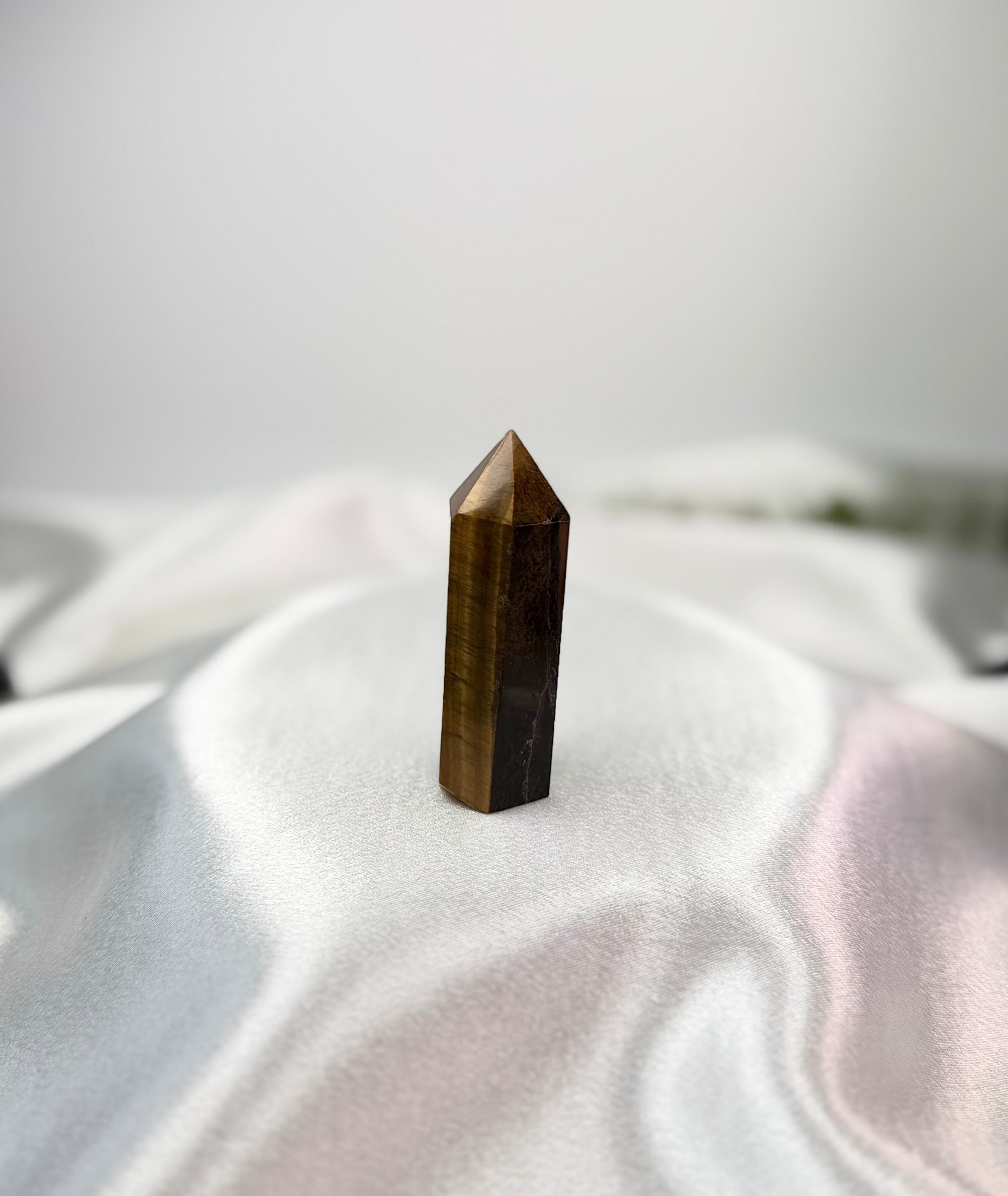Treasured Energies polished Tigers Eye crystal tower with a pointed tip and chatoyant golden-brown banding.