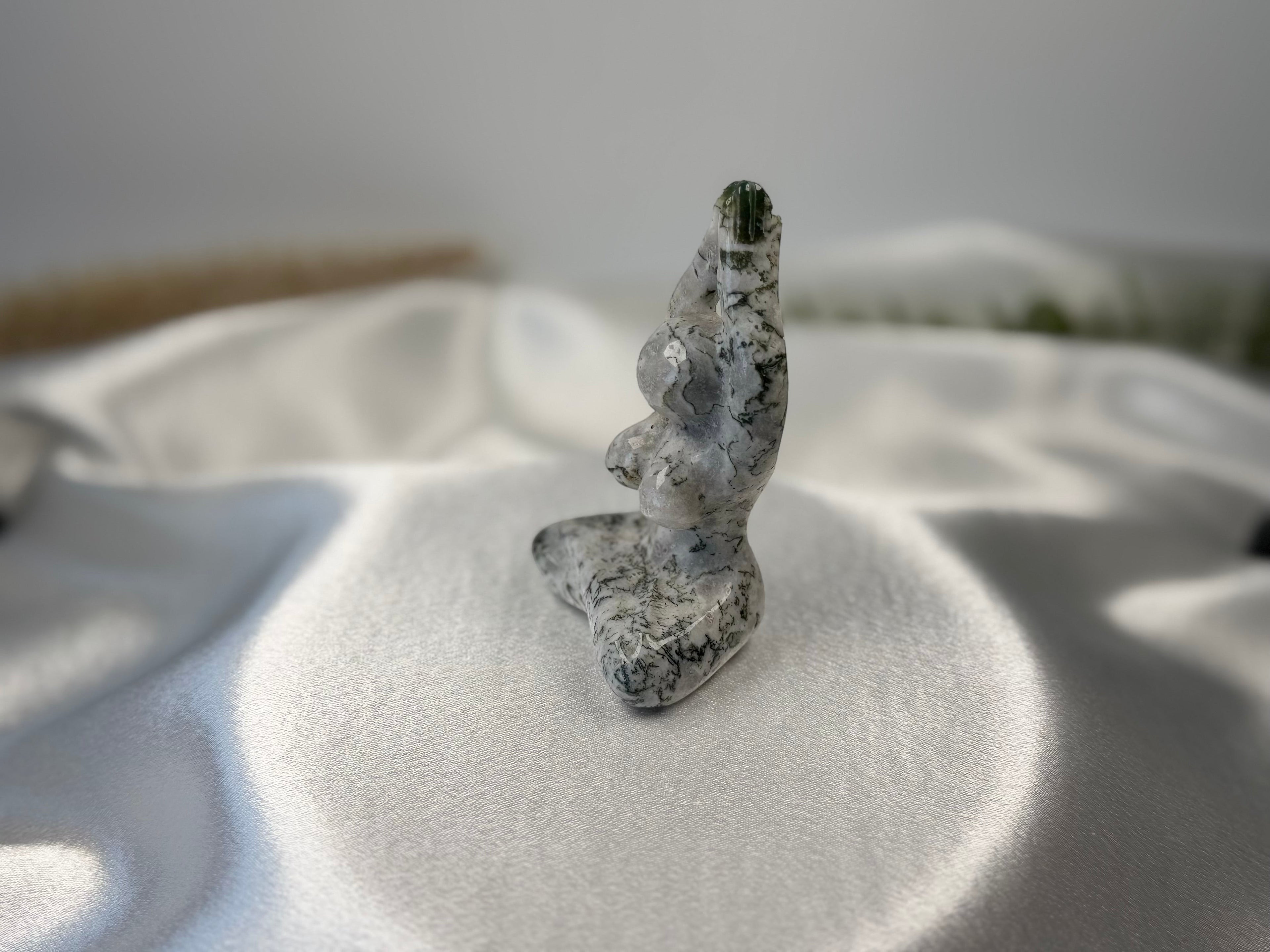Treasured Energies tree agate yoga woman carving with dendritic forest patterns on a white satin background