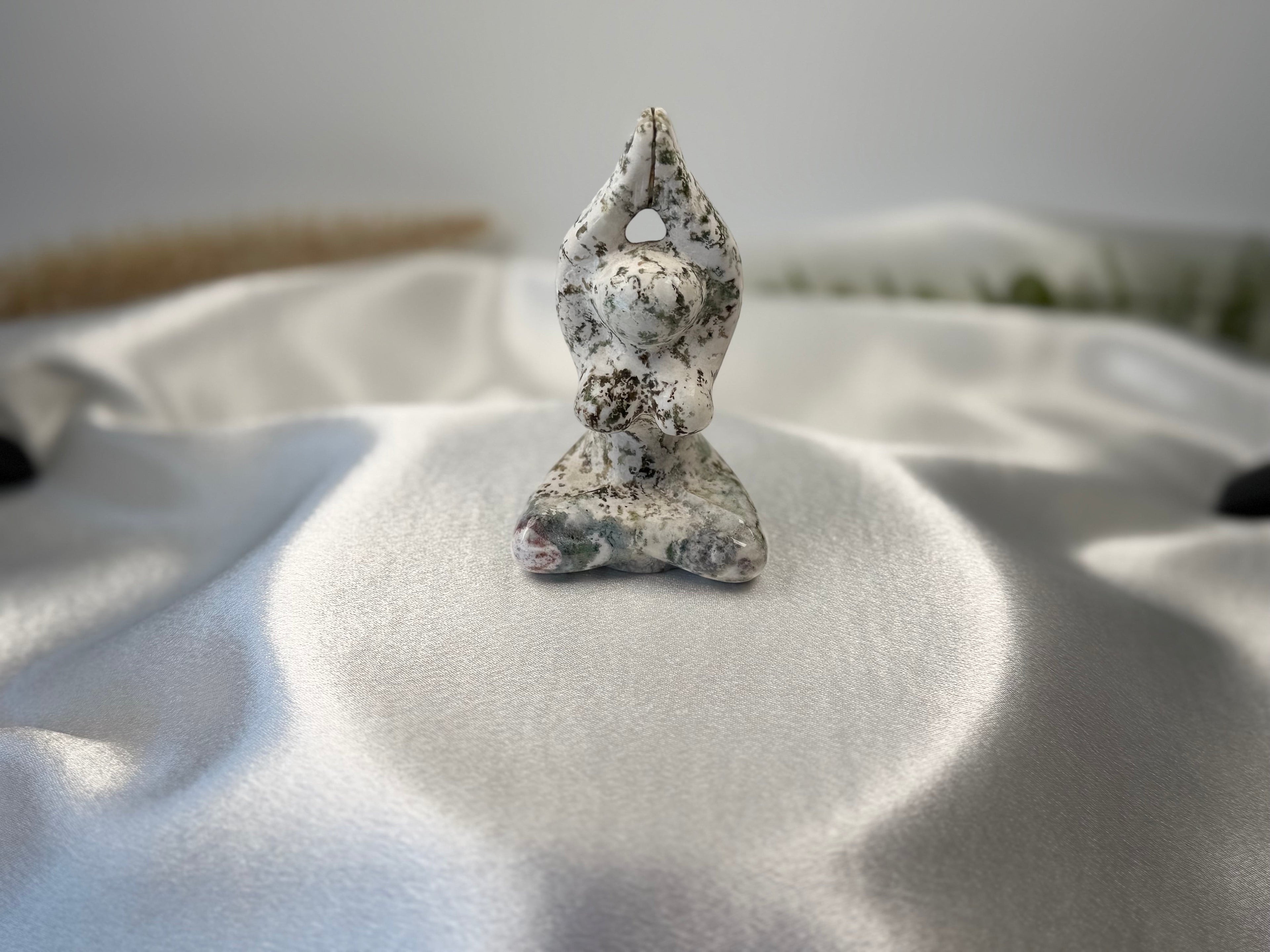 Treasured Energies tree agate yoga woman carving with white and green dendritic patterns on a satin background