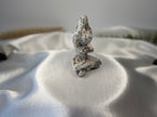 Treasured Energies tree agate yoga woman carving with white and green dendritic patterns on a satin background