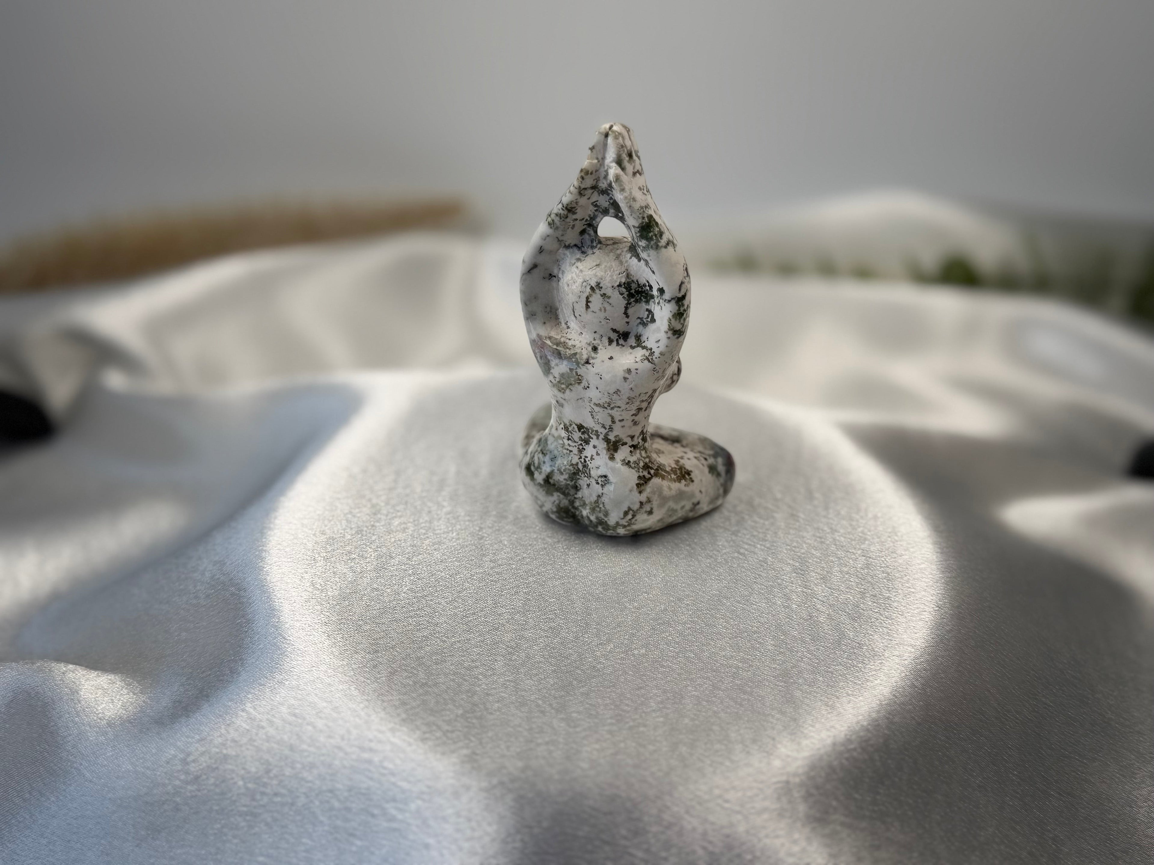 Treasured Energies tree agate carving of a woman in a yoga pose with white and green dendritic patterns